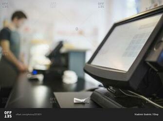 Close Up Of Checkout Counter With Cashier In Background At Coffee