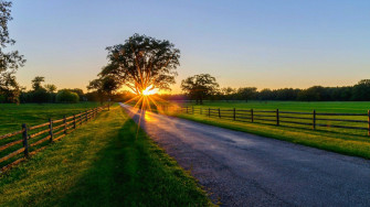 A Peaceful Path Through The Countryside During Stunning Sunrise Wallpaper