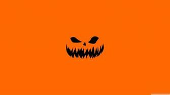 Scary Halloween Face On Orange Background Wallpaper Holidays