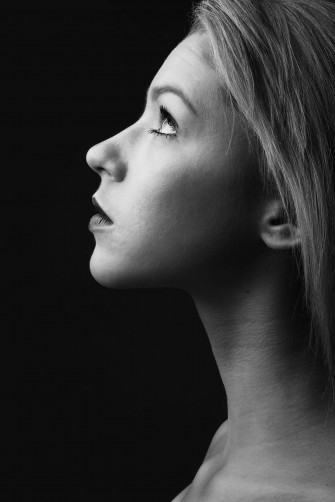 A Black And White Photo Of Woman With Her Head Up Wallpaper