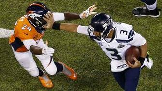 Stiff Arms Broncos Cornerback Champ Bailey On Sunday During Super Bowl