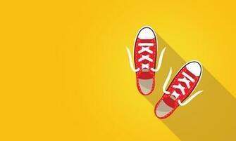Photo Red Sneakers On Bright Yellow Background Abstract