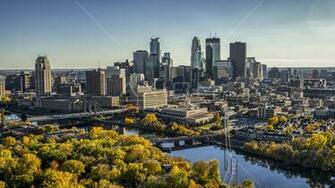 Bridges Spanning The River Near Autumn Trees And Skyline In