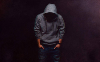 Stylish Man In Hoodie Embodying Urban Cool Wallpaper