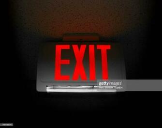Closeup Of Exit Sign On Black Background High Res Stock Photo