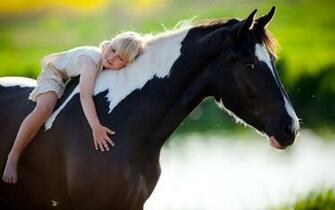 Child Sits On A Horse Click To