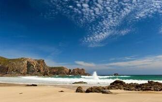 Waves Splashing On A Sandy Beach Wallpaper