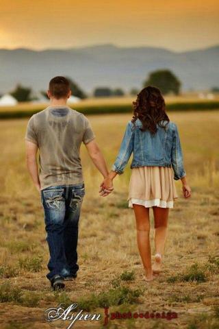 Young Couple Walking Hand In Senior Pictures