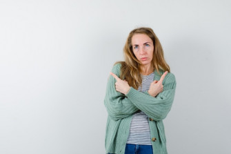 Expressive Young Woman Posing Studio Wallpaper
