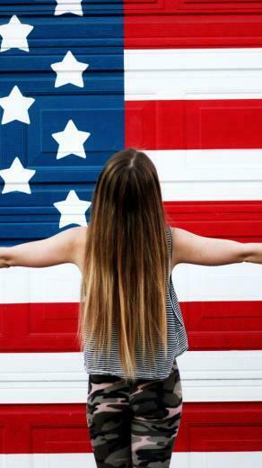 American Girl In Front Of Usa Flag United States America