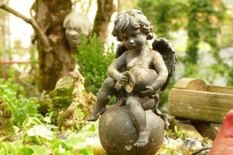 A Cherub Statue In Garden 4k Ultra HD Wallpaper Background