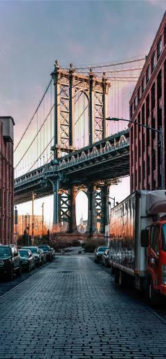 Cars Parked On Both Sides Of Street Near Bridge iPhone X