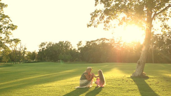 Grandmother And Granddaughter Outdoors Having A