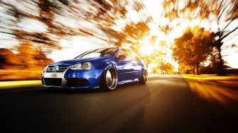 Volkswagen Golf Car In High Speed Road Autumn Sun