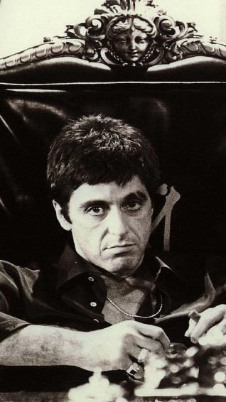 A Man Sitting In Chair Wallpaper