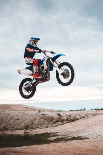 Man Riding Blue And White Motocross Dirt Bike Photo Vehicle