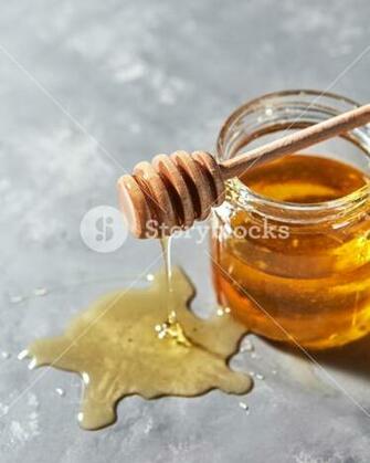 Dripping Sweet Honey Into A Puddle Of Fresh Organic Syrup On