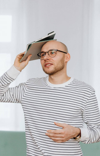 Bald Man With Books Wallpaper