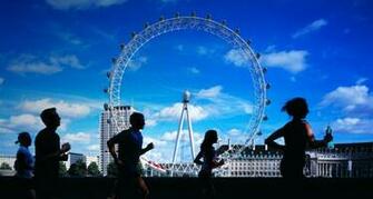 London Marathon Joggers Running By Thames Eye In Background