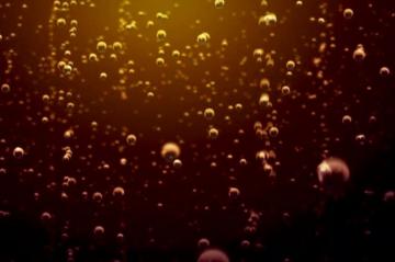 Transparent Bubbles Go Up Underwater Over Coca Cola