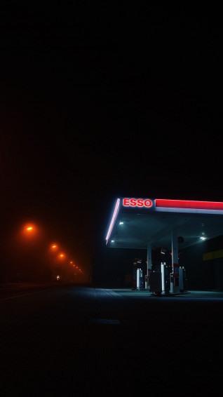 Red And White Store Signage During Night Time Photo Gas