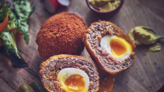 Traditional British Scotch Eggs Dish With Spinach Wallpaper