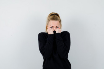 Expressive Young Woman Posing Studio Wallpaper