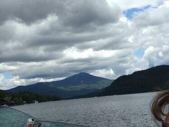Touring Lake Placid By Boat With Whiteface Mountain In Background
