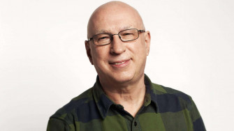 A Bald Man In Glasses And Green Shirt Wallpaper