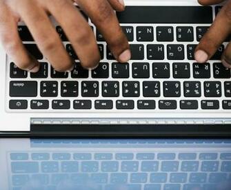 Person Typing On White And Black Laptop Computer Stock