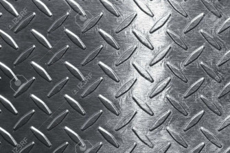 A Close Up Of Metal Plate With Diamonds Wallpaper