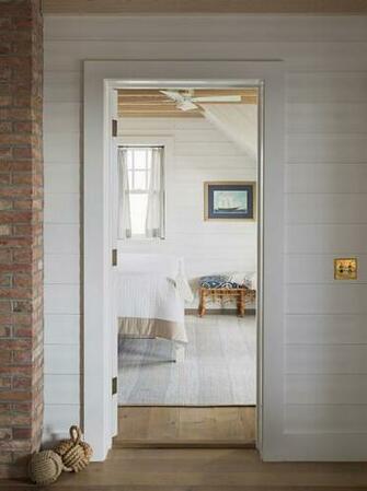 Hallway To Bedroom Features Shiplap Clad Walls Alongside Exposed Brick