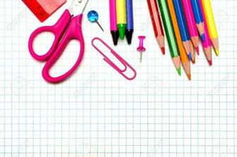 Colorful School Supplies Border Over Graphing Paper