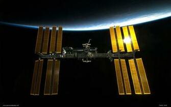 Iss And Earth The International Space Station Back Dropped By