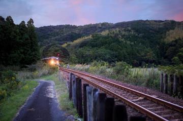 Train Comes Around Bend In Track Under Beautiful Sunset Sky