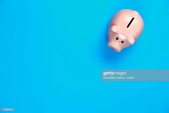 Directly Above S Of Piggy Bank Over Blue Background High Res