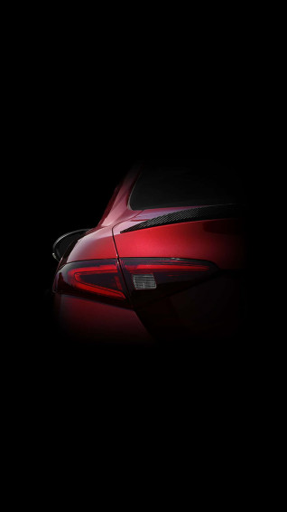 A Powerful Sleek Red Car Against Bright Blue Sky Wallpaper