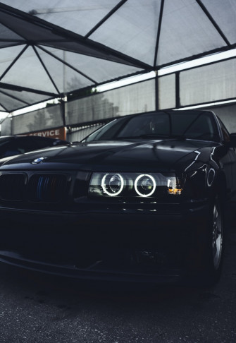 A Black Car Parked In Parking Garage Photo Transportation