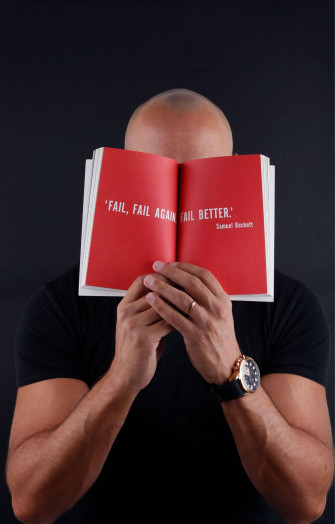 A Middle Aged Bald Man Covering His Face With Hands Wallpaper