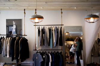 Racks With Mens Apparel On The Walls Of A Clothes Store Organization 4k HD Wallpaper
