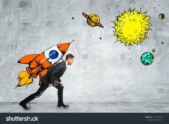 Attractive Businessman Carrying Creative Rocket Sketch On Concrete