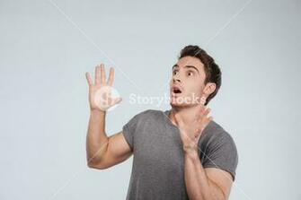Scared Shocked Young Man Looking Away And Shouting Over White
