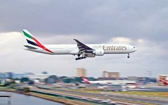White Emirates Airplane Landing During Daytime HD Wallpaper