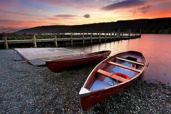 Two Brown Wooden Rowboats Docked On Lake HD Wallpaper