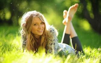 Cute Blonde In The Sunlit Grass Wallpaper