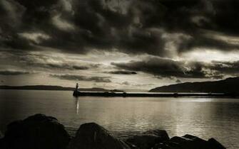 Cloudy Sky Over Lighthouse Wallpaper