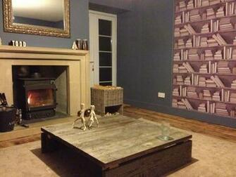 Room With Hand Made Pallet Coffee Table And Vintage Book Wallpaper