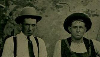 Two Men In Hats Posed Behind Park Bench Painted Background