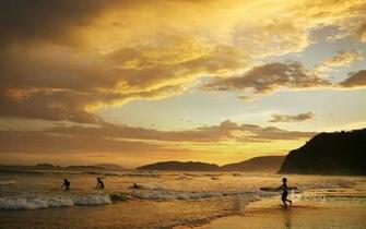 People Surfing At Dusk Geriba Beach Buzios Brazil Mark