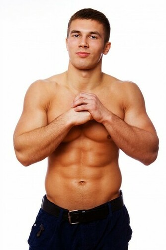 Portrait Of Muscle Man Posing On White Background In Studio